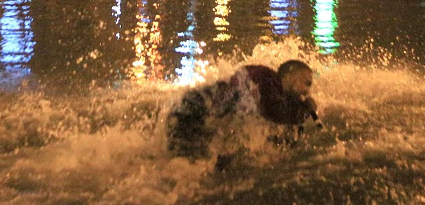 Kanye West jumps into water 